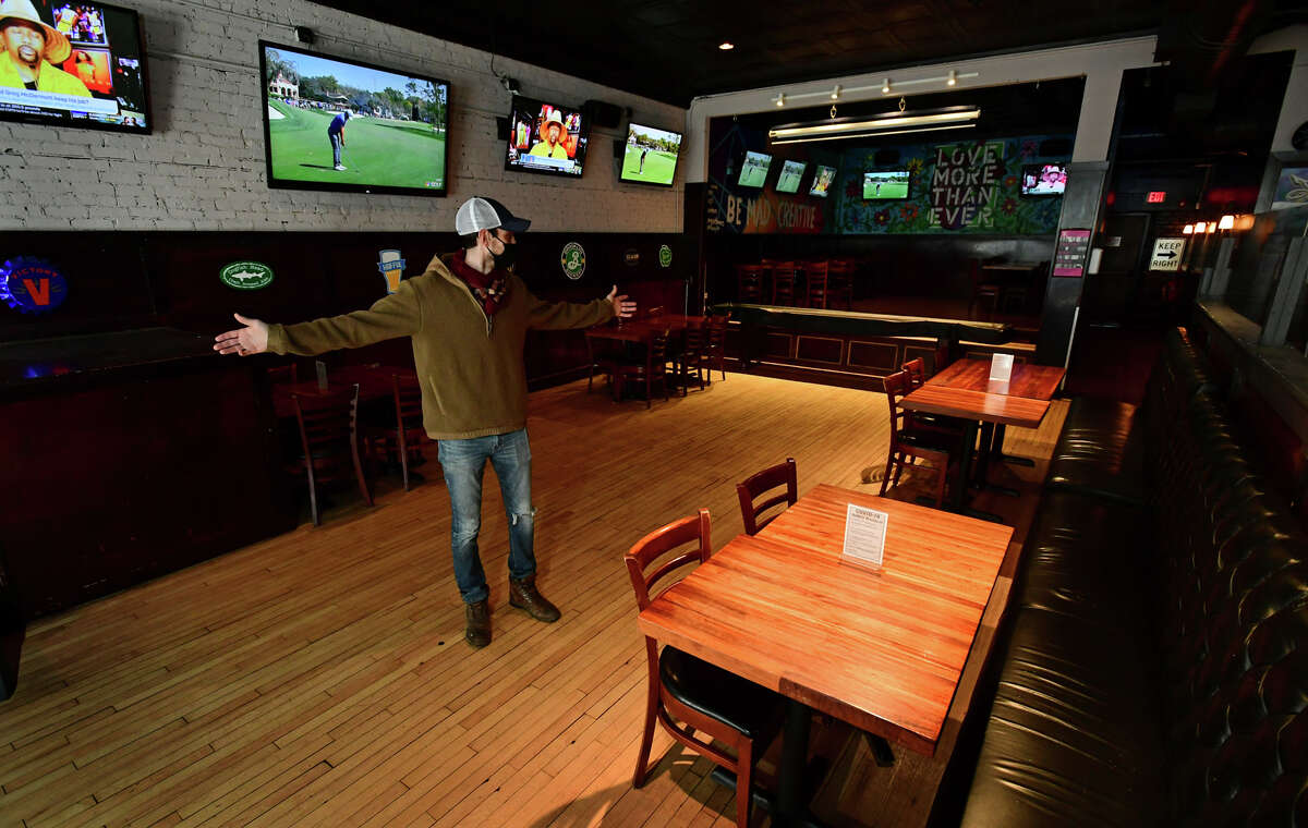 Blind Rhino owner Matt Bacco prepares his restaurant with socially distanced seating Friday, March 4, 2021, in Norwalk, Conn. The state issued a COVID restriction easement for restaurants allowing for more dining with specified distance between tables.
