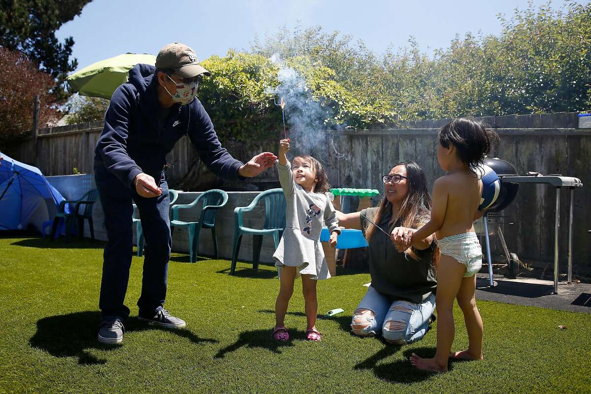 Filipina American nurse Juliet Palarca (second from right), who has faced racism during the pandemic, celebrates the Fourth of July in S.F. with father Cesar Palarca, daughter Tala Tito, and son Tamati Tito.