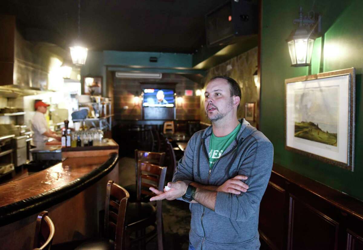 Manager Daniel Silver chats about new measures in place for restaurants due to the coronavirus at MacDuff's Public House in Greenwich, Conn. Monday, March 16, 2020.