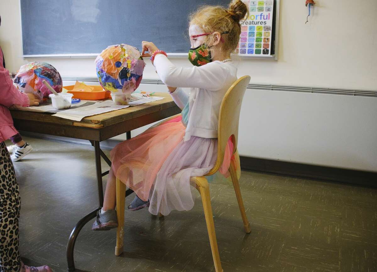 Castle Island Bilingual Montessori school student Mia Finlan, 5, glues tissue paper to her lantern in the art studio on Thursday, Sept. 17, 2020, in Albany, N.Y. The American Rescue Plan, set to pass Congress March 9, 2021, will means billions for schools. But they're still worried it could mean less support in the years to come. (Paul Buckowski/Times Union)