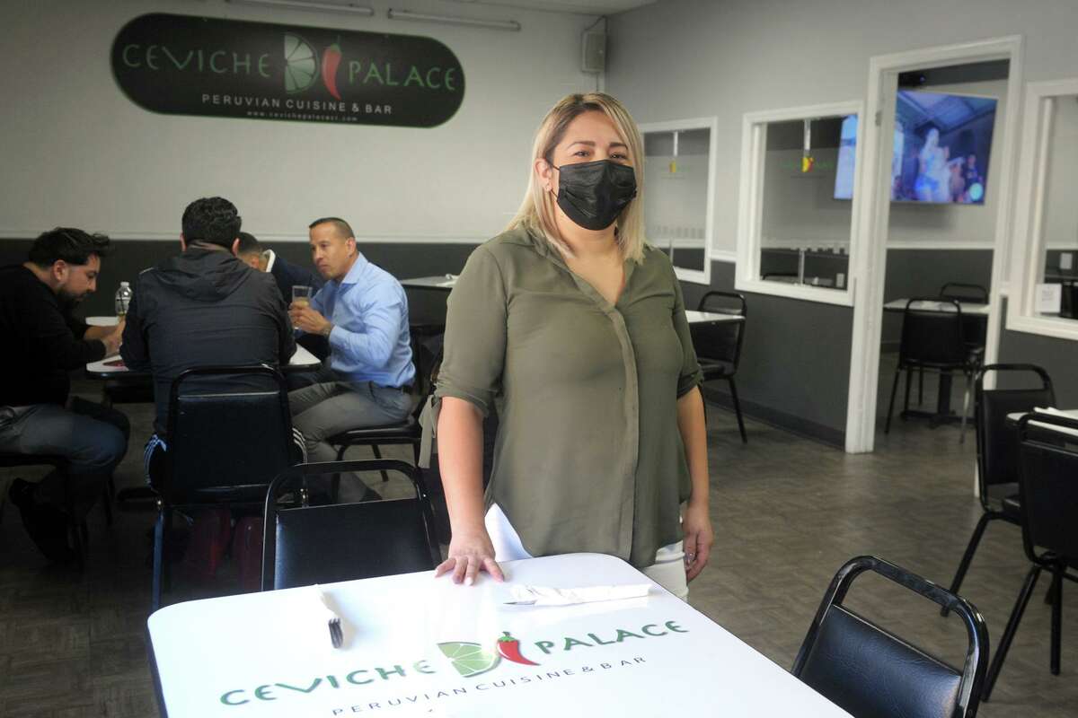Co-owner Mariella Ordonez poses in the dining room of Ceviche Palace, in Bridgeport, Conn. March 5, 2021.