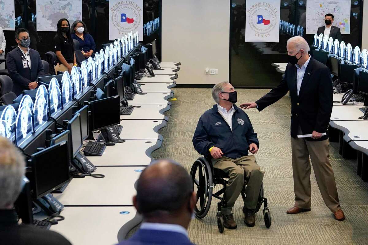 President Joe Biden talks with Texas Gov. Greg Abbott as they tour the Harris County Emergency Operations Center, Friday, Feb. 26, 2021, in Houston. (AP Photo/Patrick Semansky)