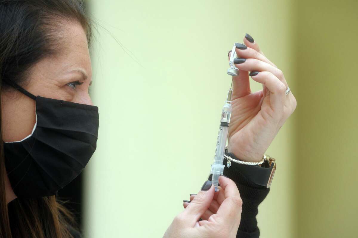 Megan Murphy, Emergency Management Director for the Town of Trumbull, fills syringes with the new Johnson & Johnson COVID-19 vaccine during the vaccination clinic held for teachers and school staff in Trumbull, Conn. March 4, 2021.