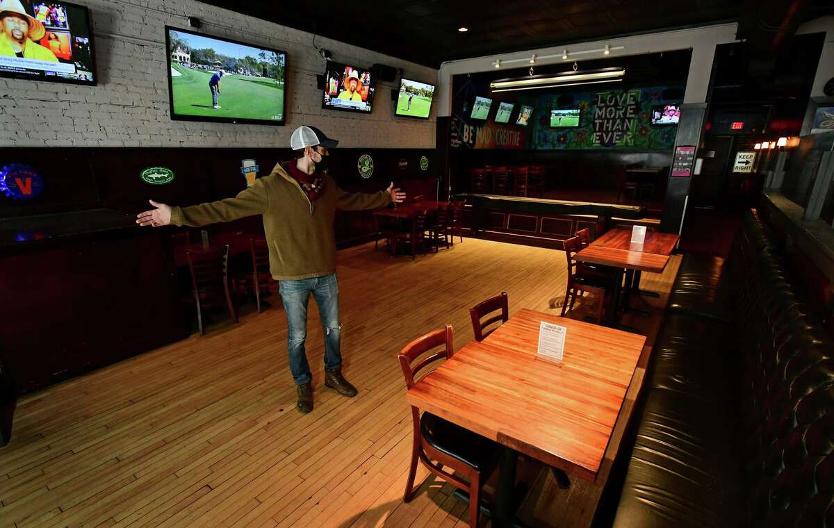 Blind Rhino owner Matt Bacco prepares his restaurant with socially distanced seating Friday, March 4, 2021, in Norwalk, Conn. The state issued a COVID restriction easement for restaurants allowing for more dining with specified distance between tables.