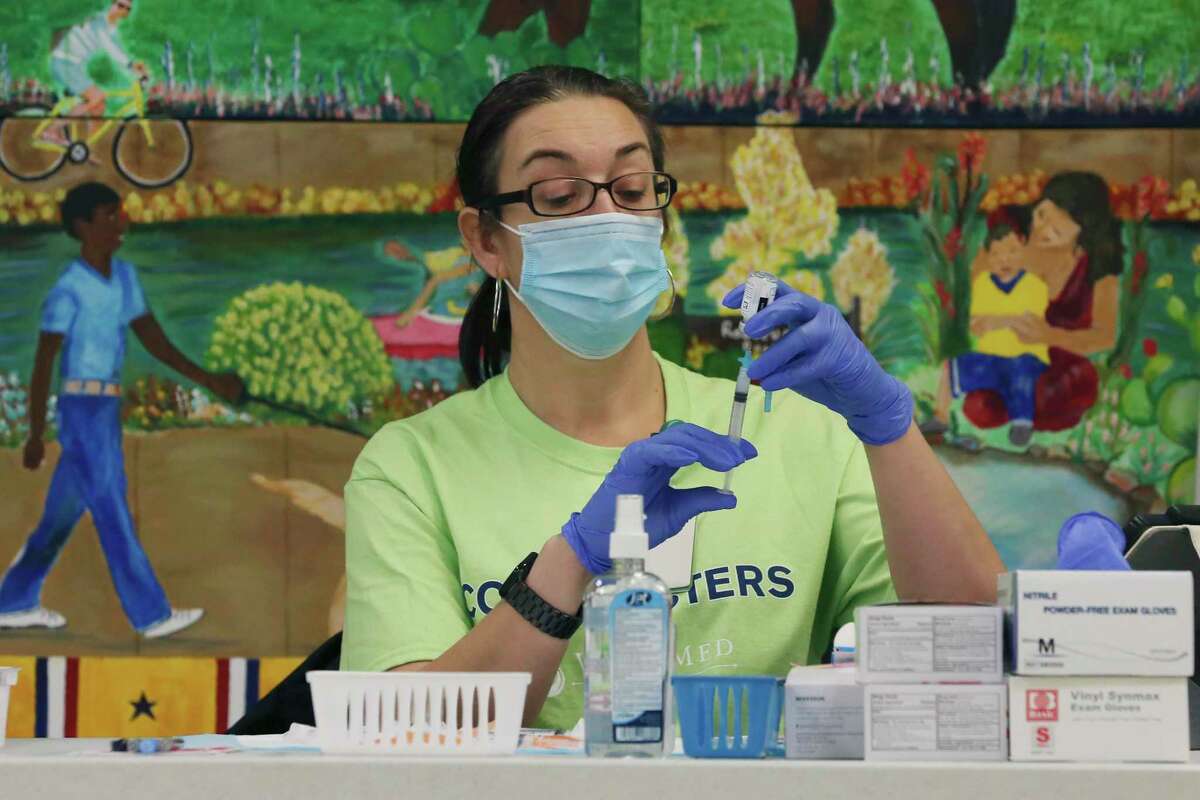Michelle Steiner draws a dosage of the Moderna COVID-19 vaccine from a vial at WellMed’s Elvira Cisneros Senior Community Center on Feb. 22.