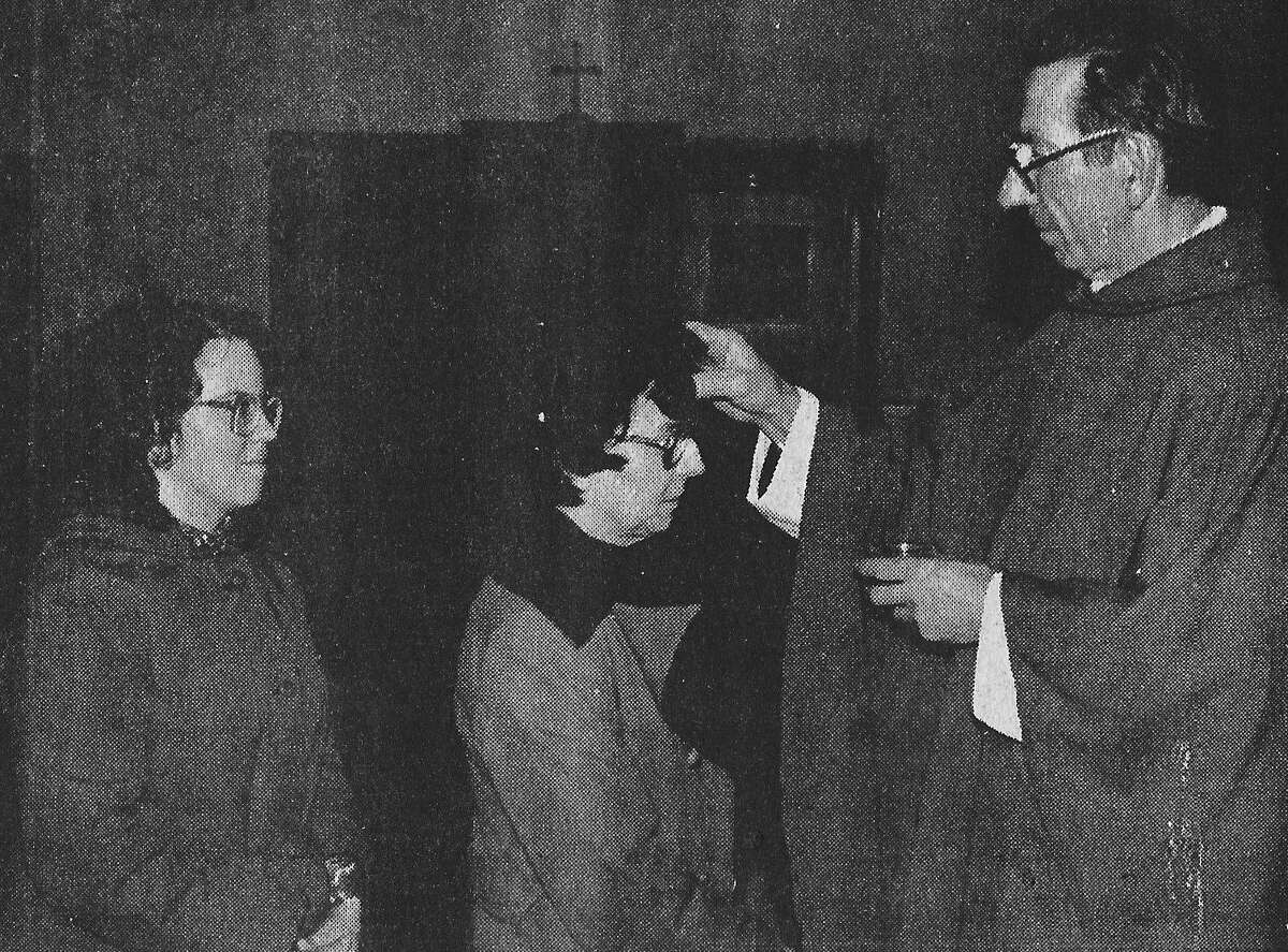 The Christian community the world over began its observance of Lent this past week. Pictured are the Rev. Father Clarence Smolinski of Manistee St. Joseph's Catholic Church made a sign of the cross in ashes on the forehead of these parishioners who were among those participating in the traditional Ash Wednesday rite. The photo was published in the News Advocate on March 5, 1981. (Manistee County Historical Museum photo)