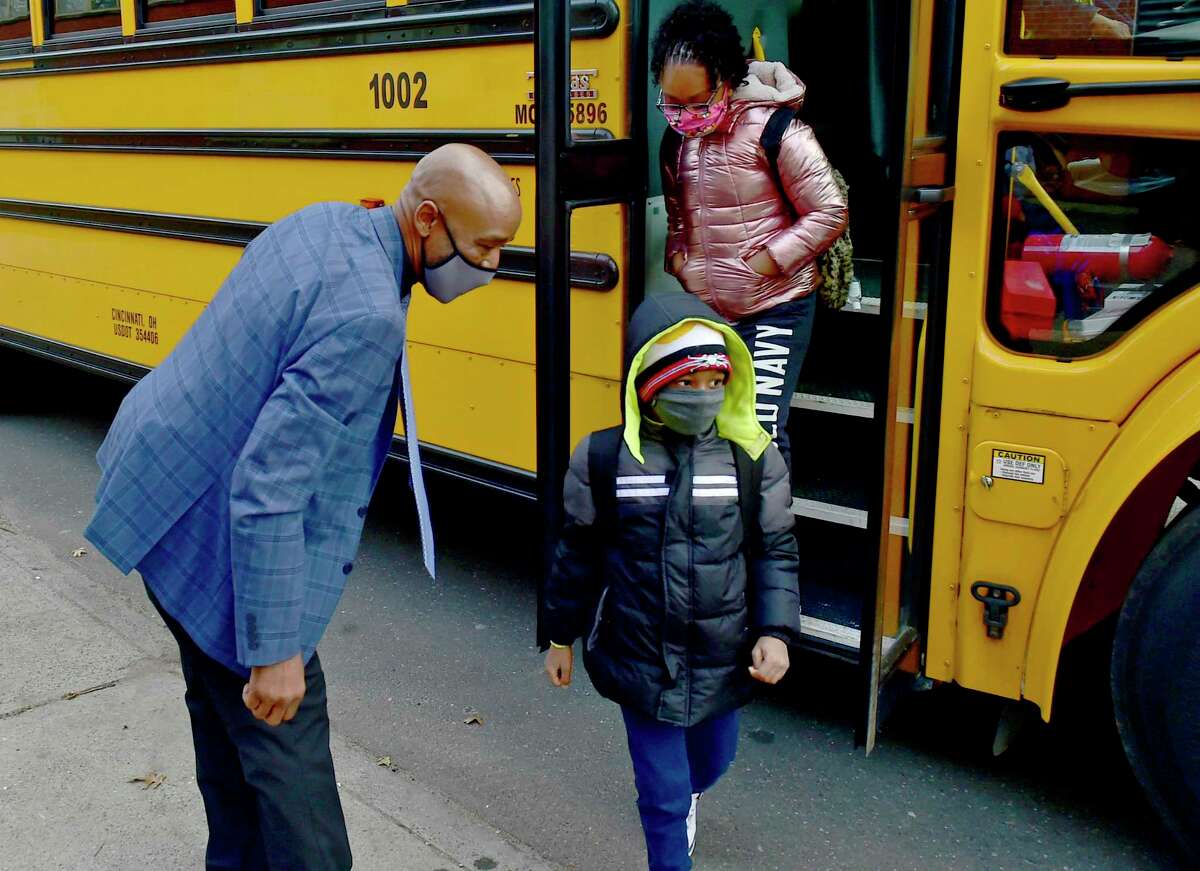 Lincoln Bassett Community School Parent Involvement Coordinator Keith Young welcomes students pre-kindergarten to 5-grade that are returning to school during Covid-19 pandemic in New Haven on Jan. 19.