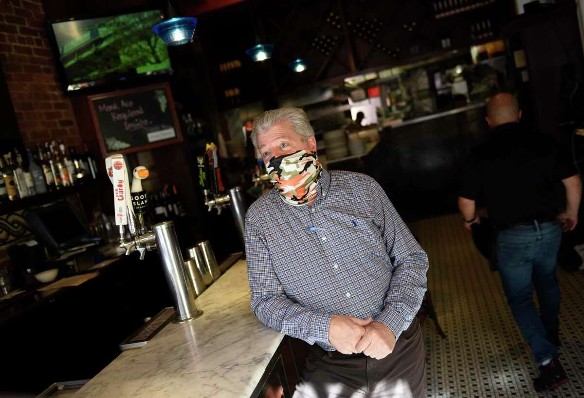 Manager Anthony Salvatore chats at Elm Street Oyster House in Greenwich, Conn. Monday, Nov. 9, 2020. Coronavirus regulations are being rolled back to an amended version of Phase 2, being dubbed Phase 2.1, which includes a mandatory 10 p.m. closing time.