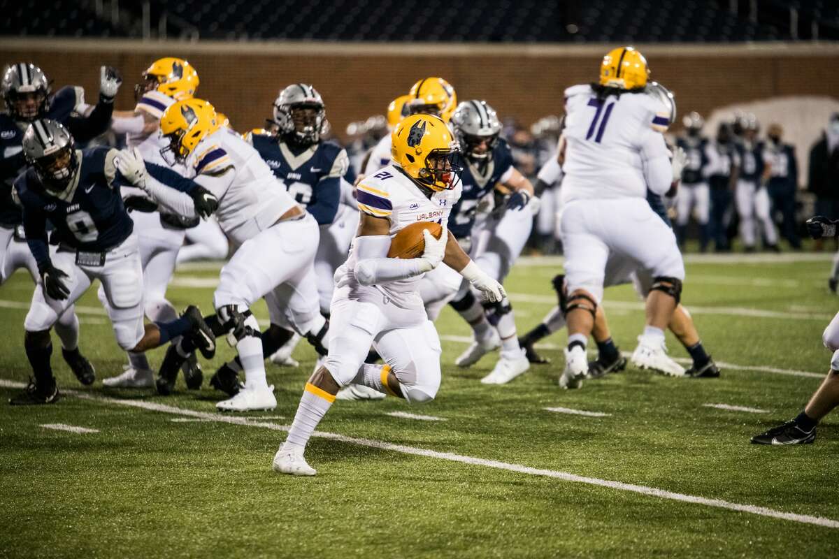 UAlbany running back Karl Mofor looks for running room against New Hampshire in a Colonial Athletic Association football game Friday, March 6, 2021, in Durham, N.H. (China Wong/UNH athletics)