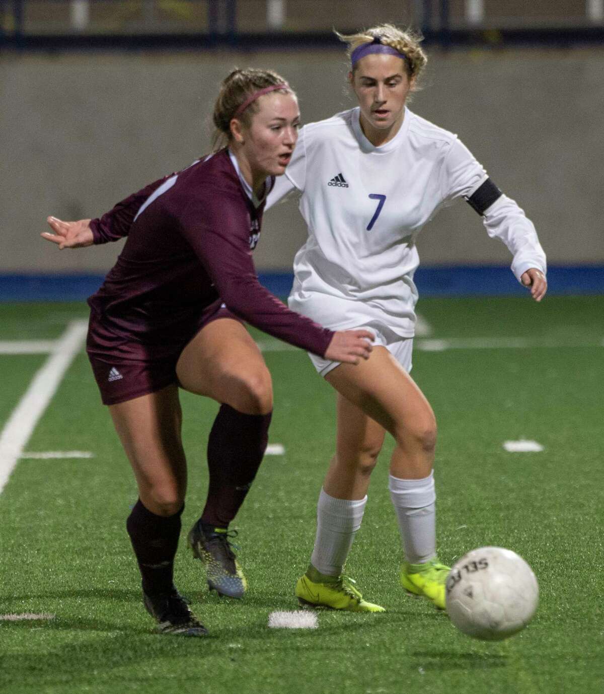Lee High's Rylee Low looks to pass as Midland High's Kinsey Hill defends 03/05/2021 at Grande Communications Stadium. Tim Fischer/Reporter-Telegram