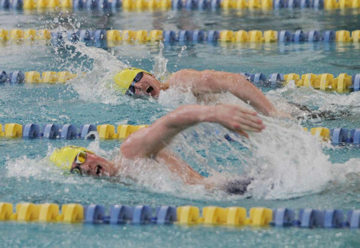 Manistee’s Ben Sullivan and Trevor Adamczak swim the 200-yard freestyle relay on Friday at the Paine Aquatic Center.