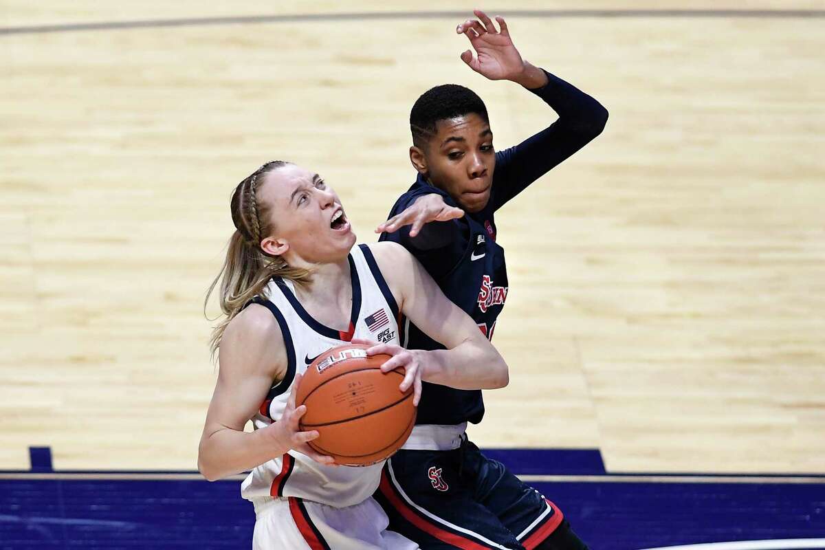 UConn’s Paige Bueckers, left, looks to shoot while pressured by St. John’s Kadaja Bailey during the first half the Big East tournament quarterfinals at Mohegan Sun Arena on Saturday in Uncasville.