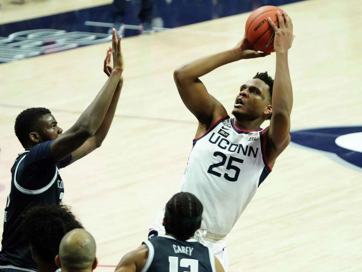 Connecticut forward Josh Carlton (25) shoots against Georgetown in the first half of an NCAA college basketball game Saturday, March 6, 2021, in Storrs, Conn. (David Butler II/Pool Photo via AP)