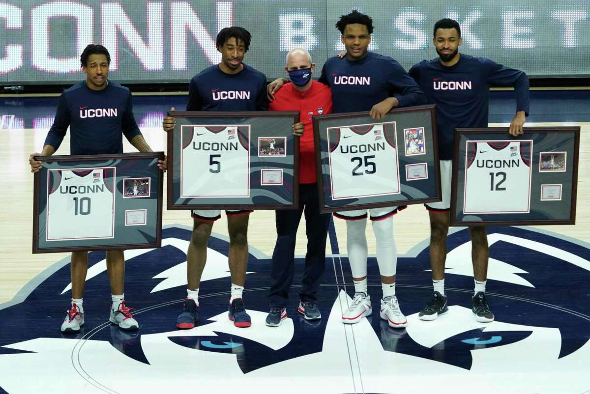 Connecticut guard Brendan Adams (10), forward Isaiah Whaley (5), head coach Dan Hurley, forward Josh Carlton (25), forward Tyler Polley (12) are recognized during senior day before an NCAA college basketball game against Georgetown, Saturday, March 6, 2021, at Harry A. Gampel Pavilion in Storrs, Conn. (David Butler II/Pool Photo via AP)