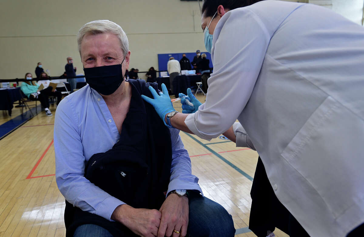 Darien Superintendent of Schools, Alan Addley, gets vaccinated against the coronavirus Saturday, March 6, 2021, at Town Hall in Darien, Conn.