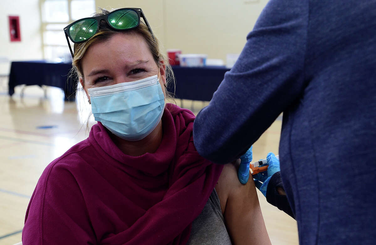 Tokeneke speacher education teacher Kory Brown gets vaccinated against the coronavirus Saturday, March 6, 2021, at Town Hall in Darien, Conn.