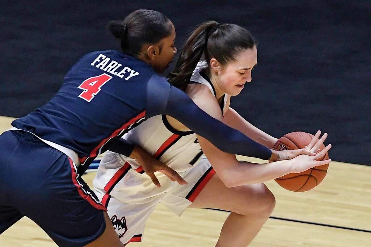 UConn’s Nika Mühl, right, steals the ball form St. John’s Raven Farley during the first half of the Big East Conference tournament quarterfinals on Saturday at the Mohegan Sun Arena in Uncasville.