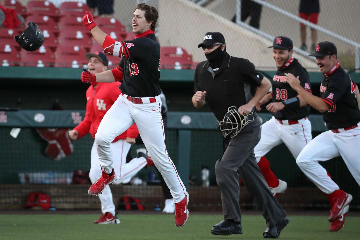 Houston outfielder Tyler Bielamowicz (13) celebrates as he rounds the bases after hitting a walkoff solo home run off Texas reliever Aaron Nixon in the 11th inning of an NCAA college baseball game at Don Sanders Field Saturday, March 6, 2021 in Houston. The Cougars topped the Longhorns 3-2 in 11 innings.