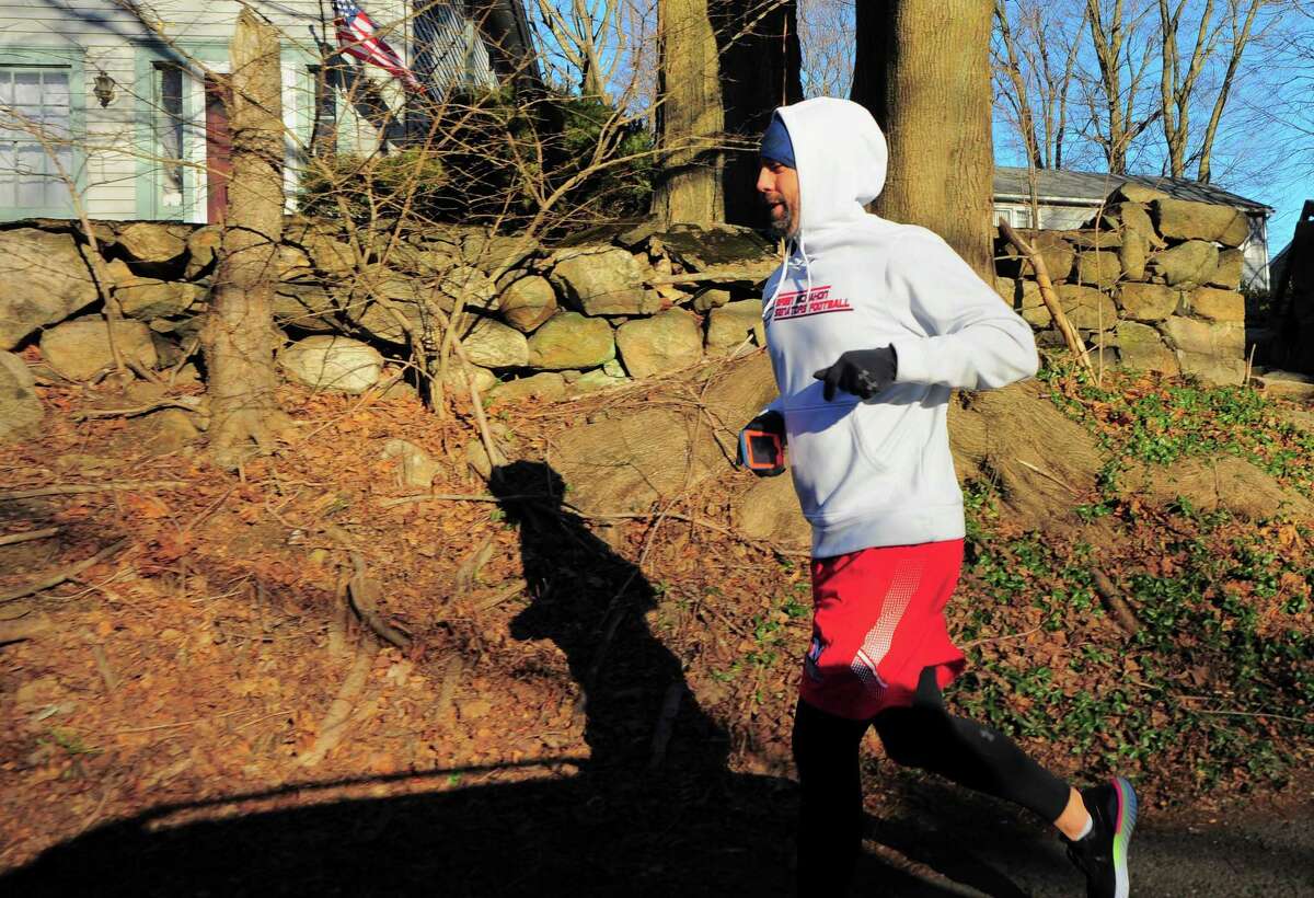 Brien McMahon High School football coach Jeff Queiroga takes part in a 48 miles in 48 hours challenge to raise money for charity in Norwalk, Conn., on Friday Mar. 5, 2021.