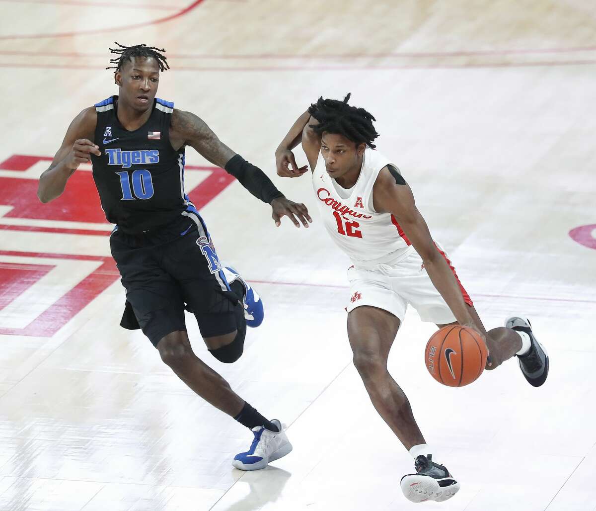 Houston Cougars guard Tramon Mark (12) heads up the court against Memphis Tigers guard Damion Baugh (10) during the second half of an NCAA Menâs basketball game at the Fertitta Center, Sunday, March 7, 2021, in Houston.
