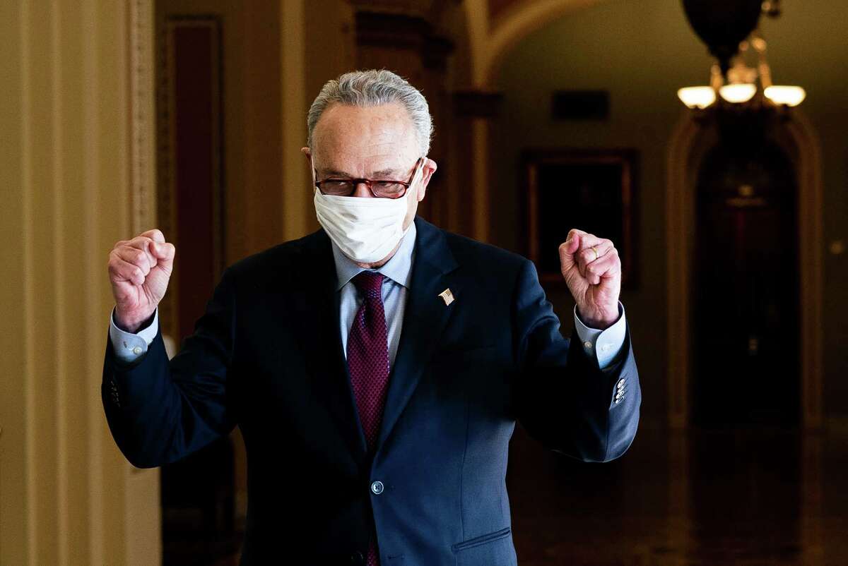Senate Majority Leader Chuck Schumer (D-N.Y.) celebrates after the passage of President Joe Biden’s $1.9 trillion stimulus bill, on Capitol Hill in Washington, Saturday, March 6, 2021. Biden’s sweeping bill passed a deeply divided Senate on Saturday over unanimous Republican opposition, as Democrats pushed through a pandemic aid plan that includes the largest antipoverty effort in a generation.