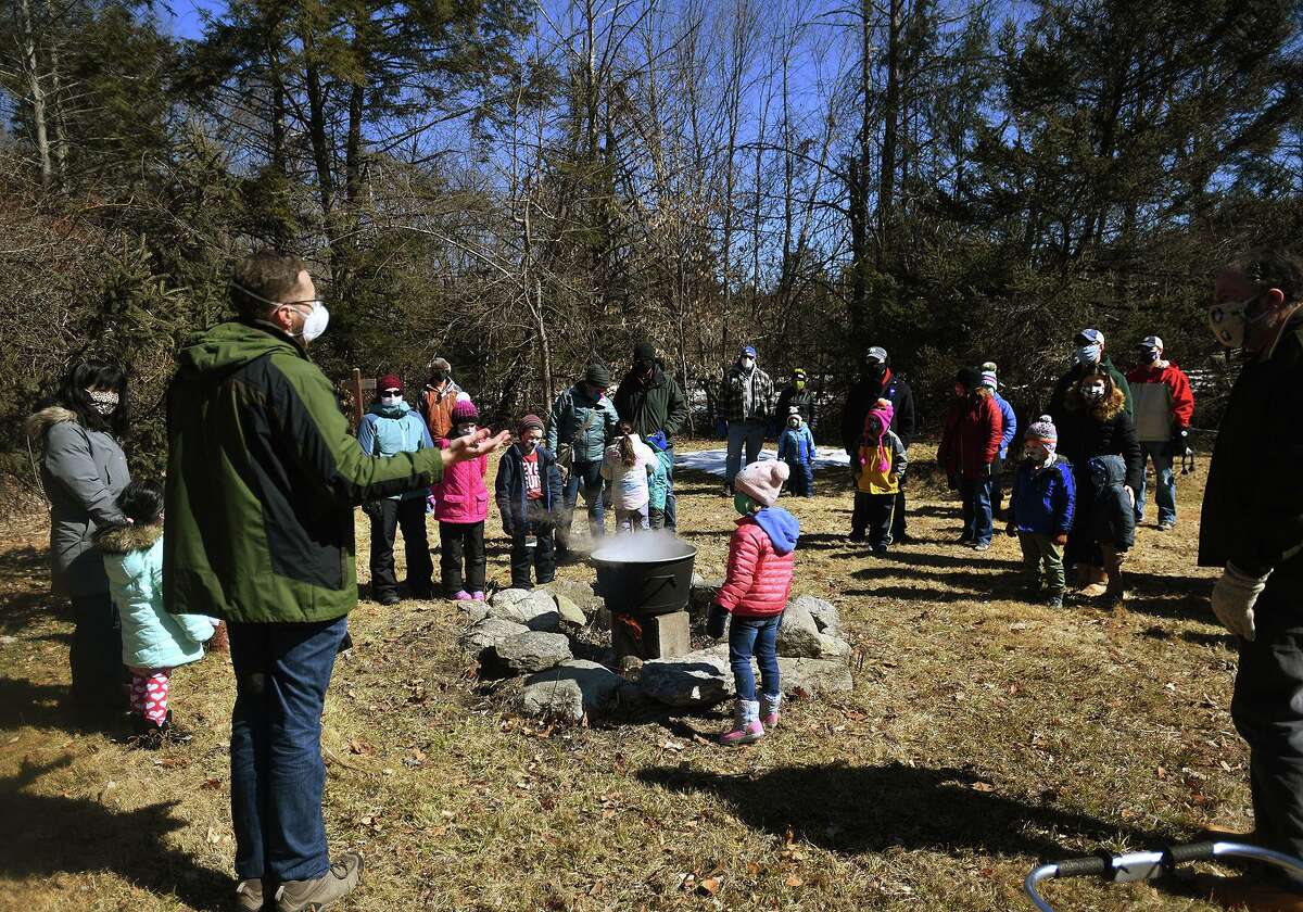 Nature and Arts Center instructor Mark Ceneri, left, leads a maple sugaring demonstration at the center in Trumbull, Conn. on Sunday, March 07, 2021.