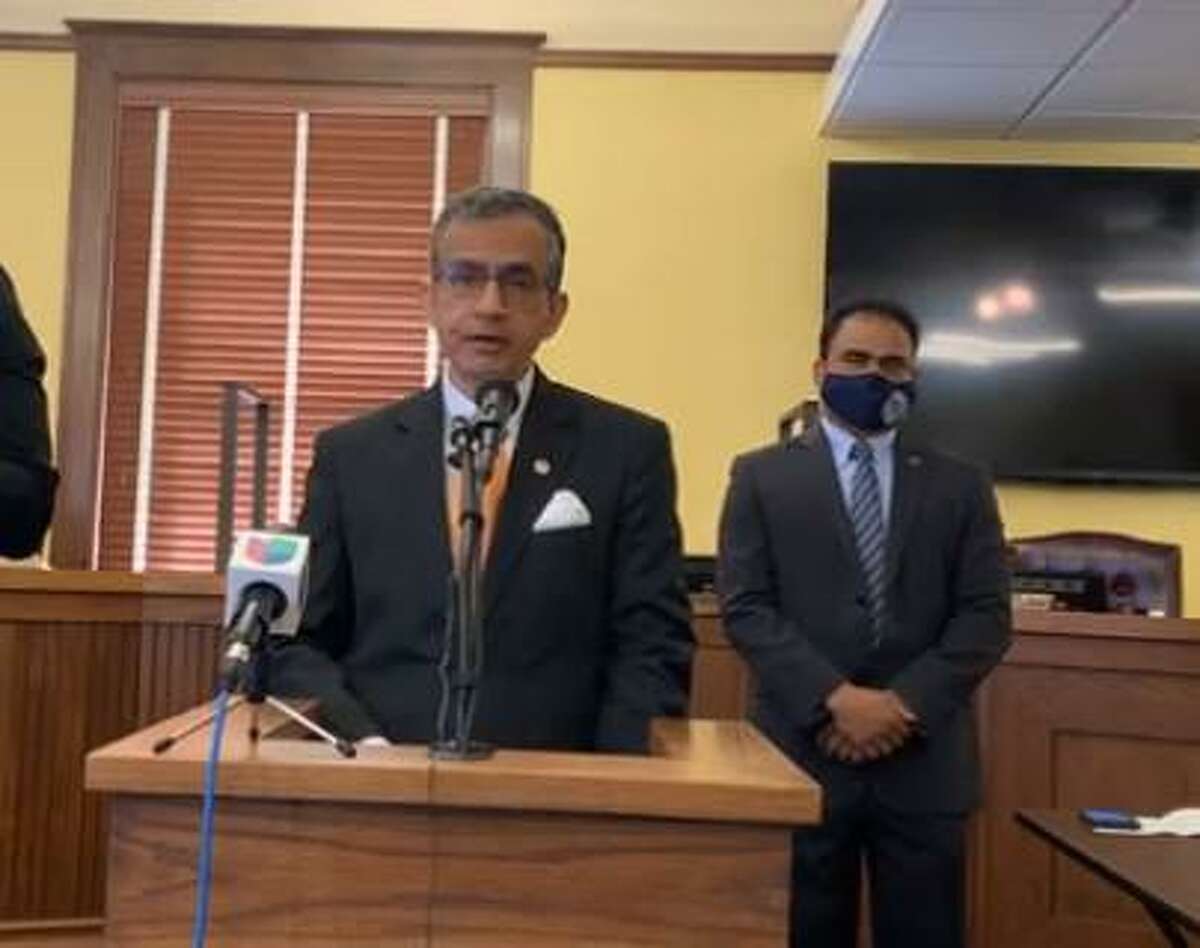 Quaisar Imam, child care voucher program director, speaks at a press conference Monday, March 8, 2021 as Fort Bend County Judge KP George looks on.