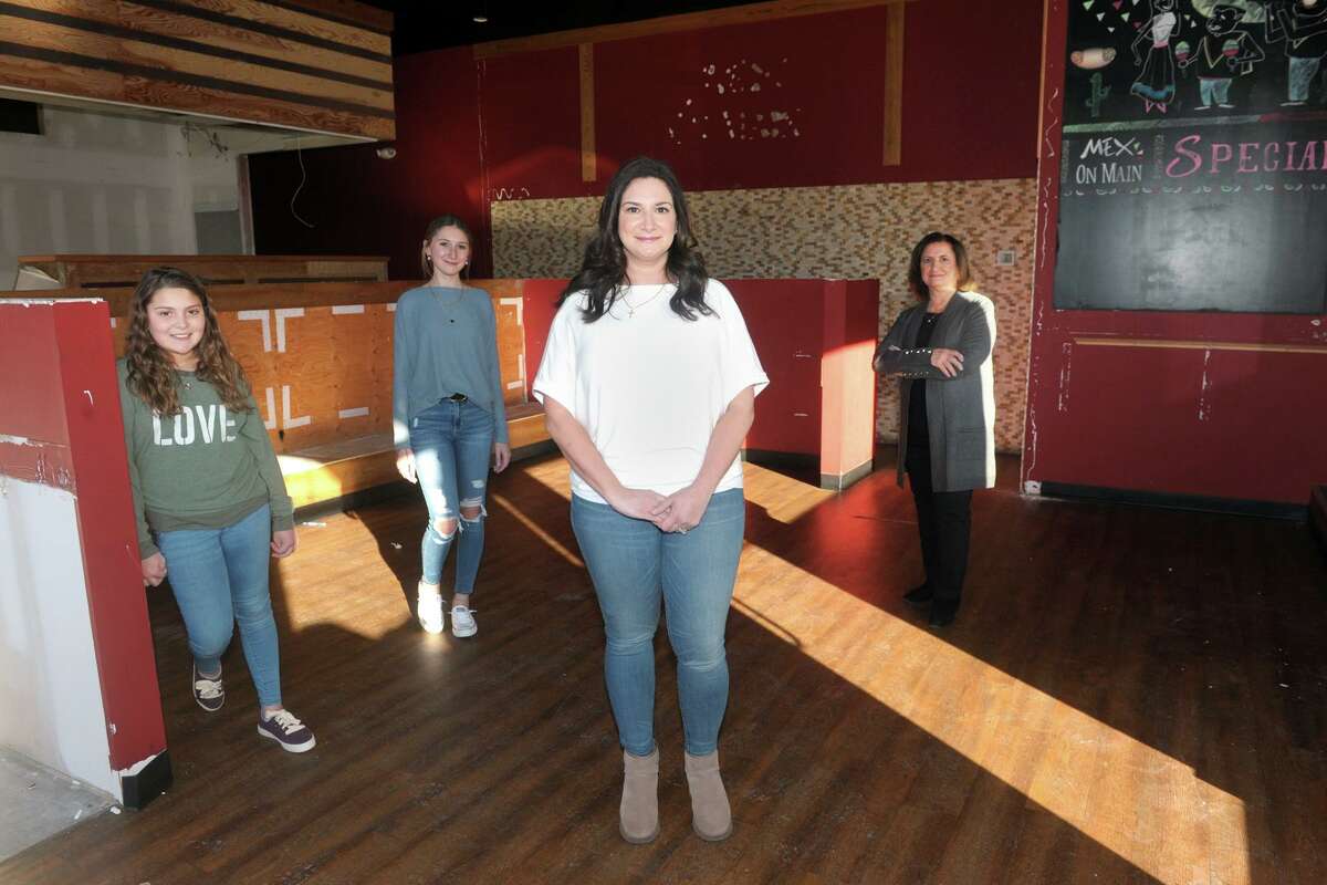 Melissa Cotto, owner, poses with some of her family in the restaurant space that will soon become Marianna's Pantry, in Trumbull, Conn. March 5, 2020. Cotto is seen here with her daughters, Liana and Alexandra, and her mother Marianna.