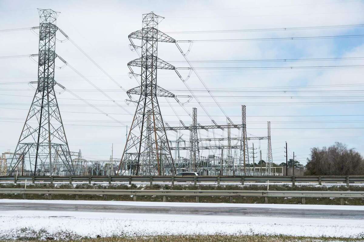 Power lines are shown near Beltway 8 the Hardy Toll Road following an overnight snowfall Monday, Feb. 15, 2021 in Houston. Temperatures plunged into the teens with light snow and freezing rain. Rolling blackouts throughout the state cut power to many.