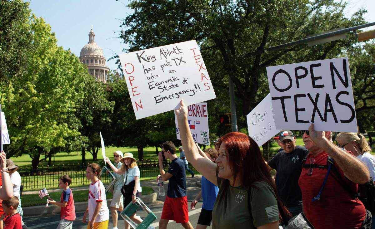 Protesters took to the street to march around the Governors Mansion over their disagreement with Gov. Greg Abbott handling of Covid-19 with mask mandates and business closures and restrictions at the Governor’s Mansion on October 10, 2020 in Austin, Texas.