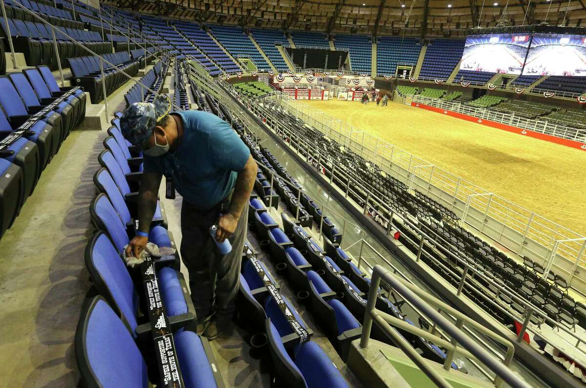 Sotero Gutierrez cleans a row of chairs inside the Freeman Coliseum on Feb. 10, 2021. Bexar County commissioners received an update Tuesday on improvements at county facilities to prevent the spread of COVID-19 and protect public health. About $1.2 million in upgrades were made at the coliseum and surrounding grounds, according to a staff report.