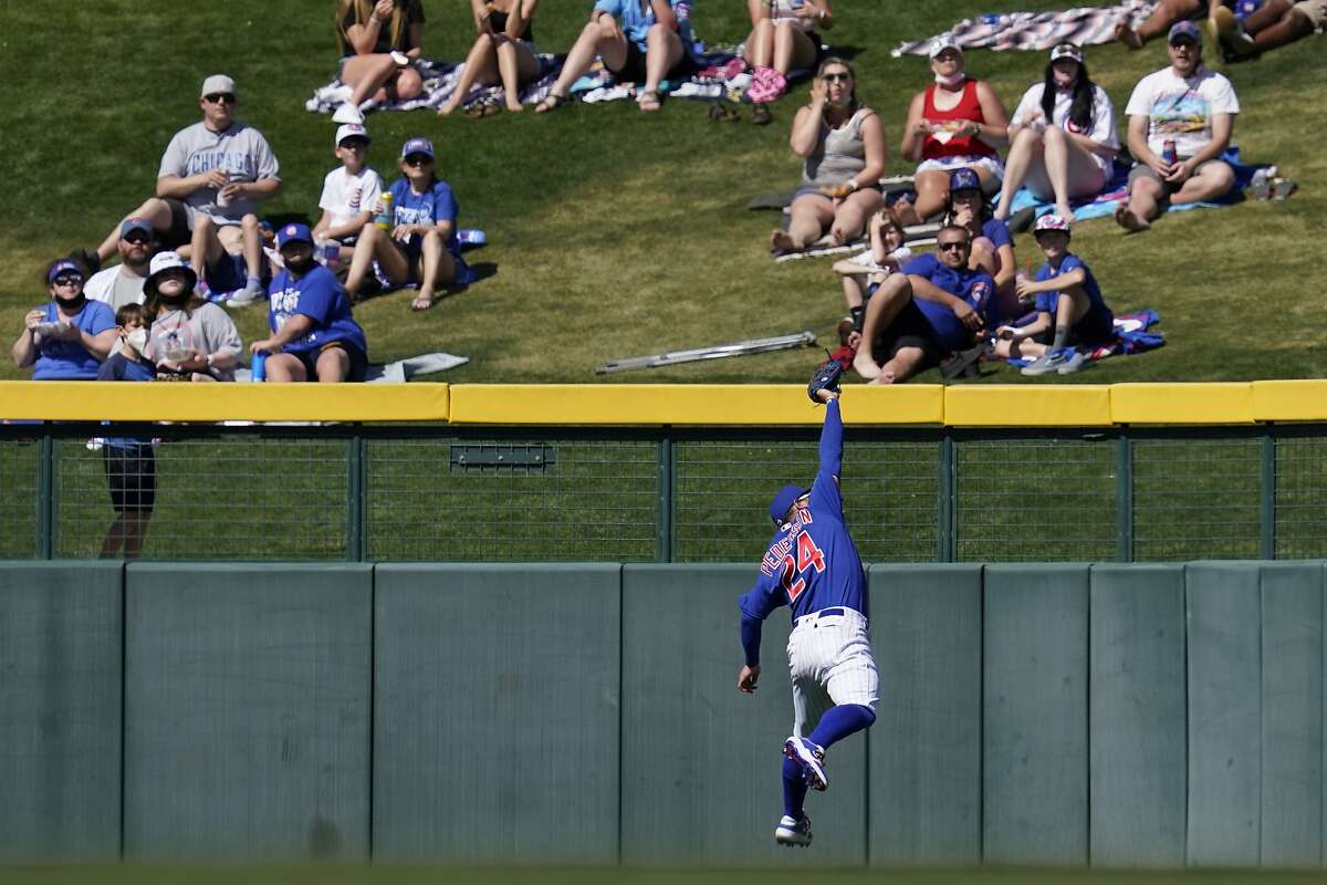 Chicago Cubs left fielder Joc Pederson (24) catches a ball hit by Texas Rangers' Willie Calhoun (5) during the fourth inning of a spring training baseball game Monday, March 8, 2021, in Mesa, Ariz. (AP Photo/Ashley Landis)