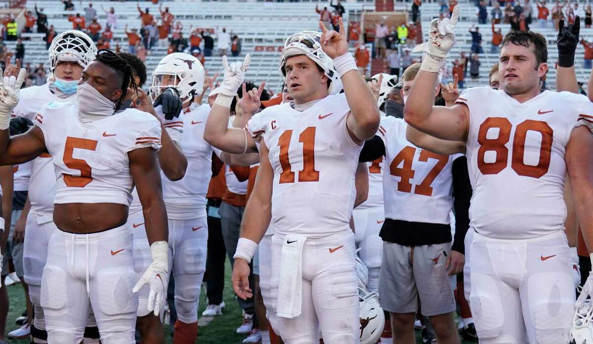 Texas players, including Sam Ehlinger (11), sing "The Eyes Of Texas" after an NCAA college football game against Baylor in Austin, Texas, Saturday, Oct. 24, 2020. (AP Photo/Chuck Burton)