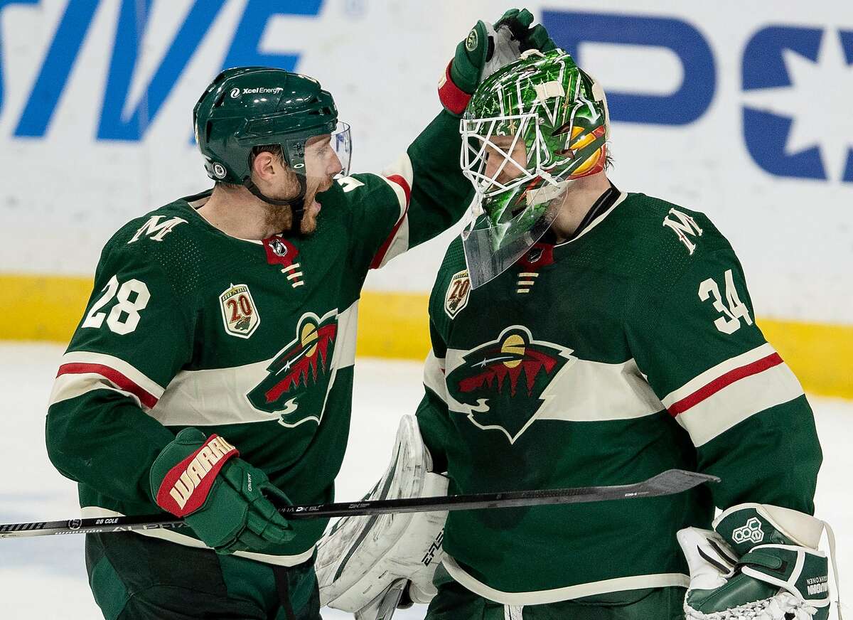Ian Cole (28) of the Minnesota Wild celebrates with goalie Kaapo Kahkonen (34) at the end of the game on March 8, 2021 between the Wild and the Las Vegas Golden Knights at Xcel Energy Center in St. Paul, Minnesota. (Carlos Gonzalez/Minneapolis Star Tribune/TNS)