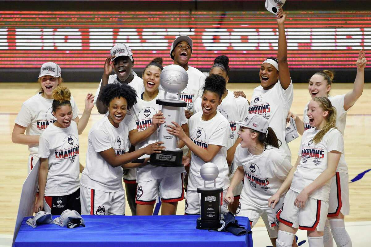 The UConn women’s basketball team celebrates its win over Marquette in the Big East Tournament championship on Monday at Mohegan Sun Arena in Uncasville.