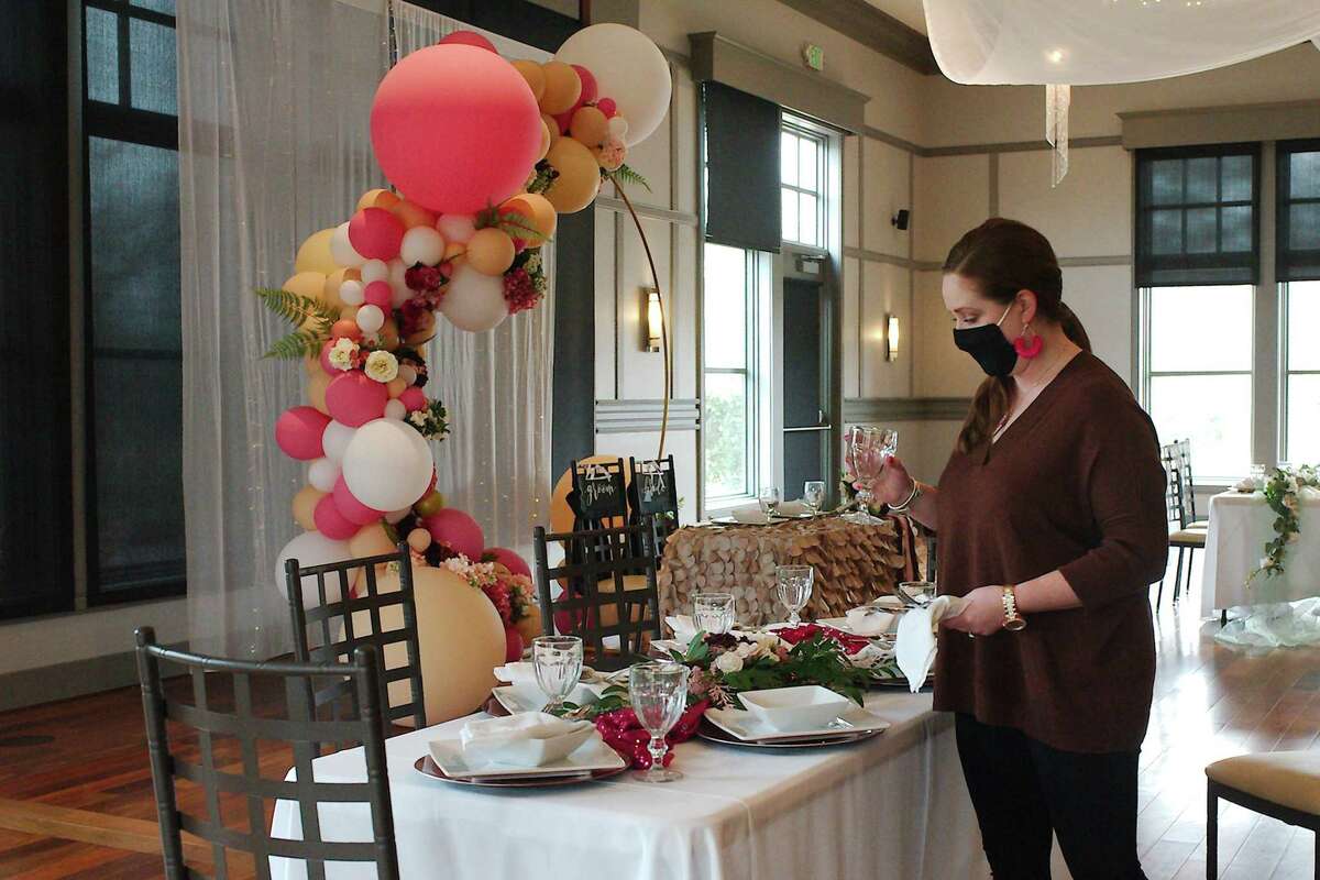 Catherine Rudolph sets a table at the WaterGrove in Dickinson.
