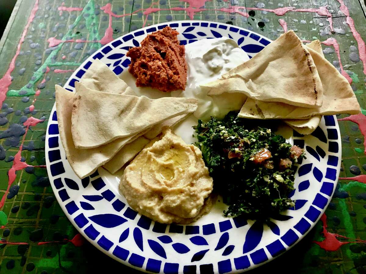 Phenicia Specialty Foods' kaleidoscope of Middle Eastern and Mediterranean cuisine includes a dinner plate of muhammara, shallot lebni, pita, tabouli and hummus.