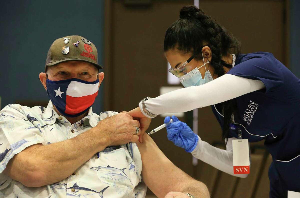 Terry Littlepage wears a Texas flag-themed mask as he receives a COVID-19 vaccination from San Antonio nursing student Maresah Olivarez at the New Braunfels Civic Center on Jan. 21. Supervised nursing students from the Galen College of Nursing San Antonio campus gave the injections to Comal County residents who had pre-registered for the event.
