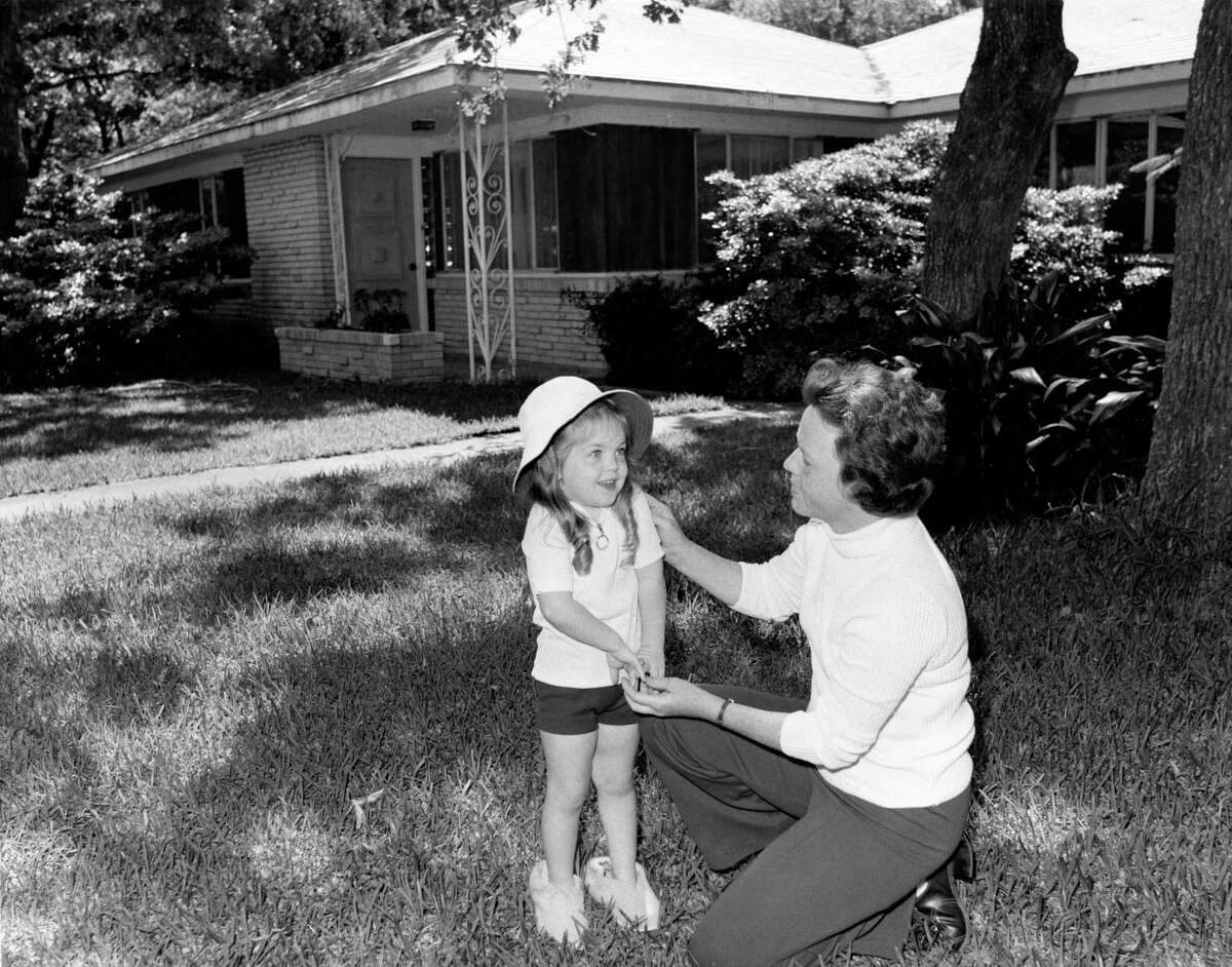 The issue of subsidence in the Houston region is not new, in this Houston Chronicle file image, mother Curtis Mouton and daughter, Janet, 3, said they hated they have to leave their Bayshore Drive home in the Brownwood Subdivision in Baytown. The neighborhood was besieged by a combination of subsidence lowering ground levels and high water from hurricanes and storms causing flooding.