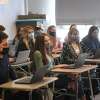 American studies students enjoy a return to a full classroom for the first time in a year at Ludlowe High School in Fairfield, Conn. on Tuesday, March 9, 2021.
