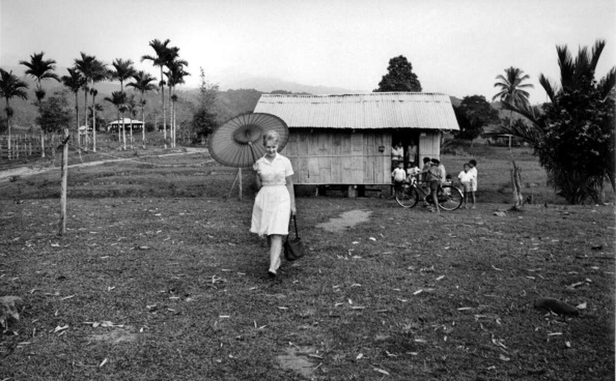Peace Corps volunteer and nurse Elizabeth Halkola visits a 'kampong,' or village, Tambunan, Malaysia, 1960s.