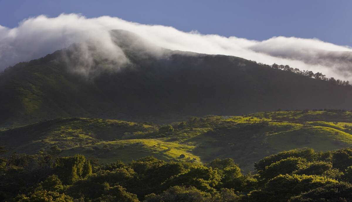 Spring fog pours over the Santa Lucia Mountains near Carmel, Calif.