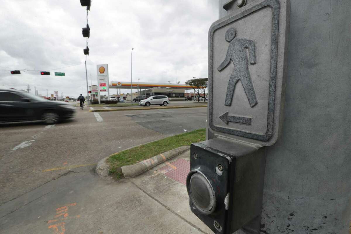 A bicyclist uses the crosswalk at the intersection of Fondren and West Bellfort on March 9, 2021, in Houston. The region’s streets are among the riskiest for pedestrians, according to a new report.