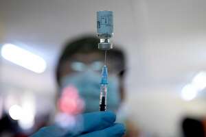A healthcare worker fills a syringe from a vial with a dose of the Johnson & Johnson vaccine against the COVID-19 coronavirus as South Africa proceeds with its inoculation campaign at the Klerksdorp Hospital on February 18, 2021. (Photo by Phill Magakoe / AFP) (Photo by PHILL MAGAKOE/AFP via Getty Images)