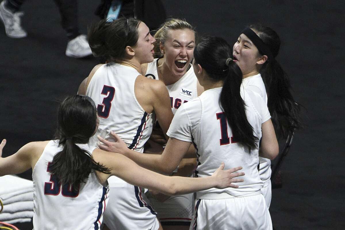 Gonzaga guard Jill Townsend, center, celebrates with teammates after scoring the winning basket against BYU in an NCAA college basketball game for the West Coast Conference women's tournament championship Tuesday, March 9, 2021, in Las Vegas. (AP Photo/David Becker)