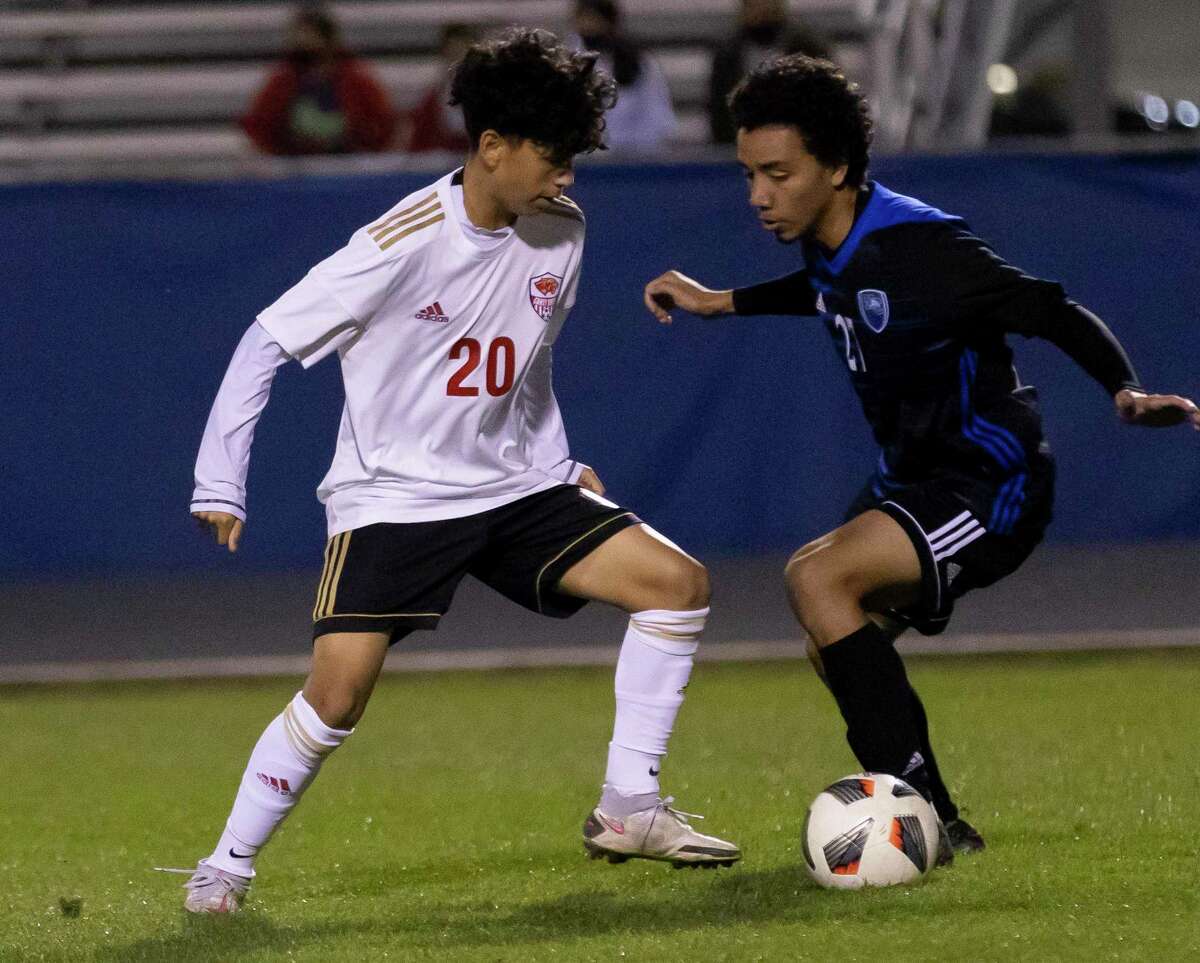 Caney Creek’s Alexis Cruz (20) and New Caney’s Ronny Del Cid fight for control of the ball during the first half of a District 20-5A boys soccer match at Don Ford Stadium, Tuesday, March 9, 2021, in New Caney.
