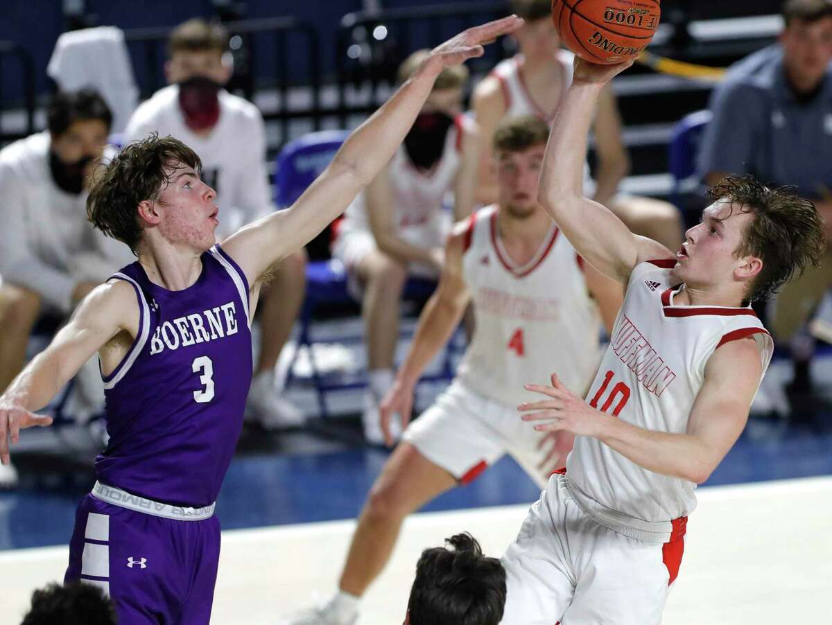 Huffman point guard Jacob Harvey (10) makes a shot past Boerne shooing guard Ben Phillip (3) during the third quarter of a Region III-4A state semifinal game at Delmar Fieldhouse, Tuesday, March 9, 2021, in Houston. Huffman defeated Boerne 55-49.