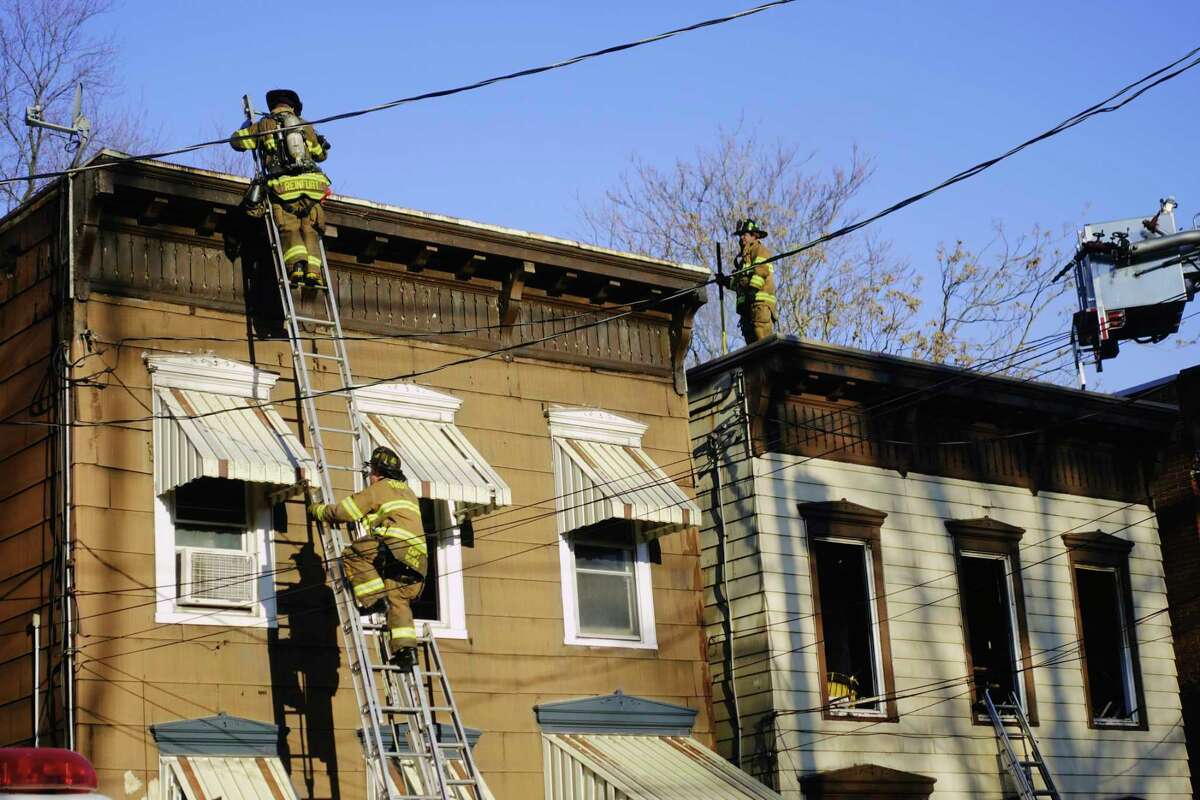 Firefighters work at the scene of a structure fire on 7th Ave. on Wednesday, March 10, 2021, in Troy, N.Y. (Paul Buckowski/Times Union)