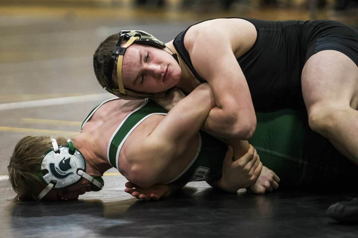 Bullock Creek's Peyton Brooks (top) wrestles an opponent from Pinconning on Jan. 23, 2019.