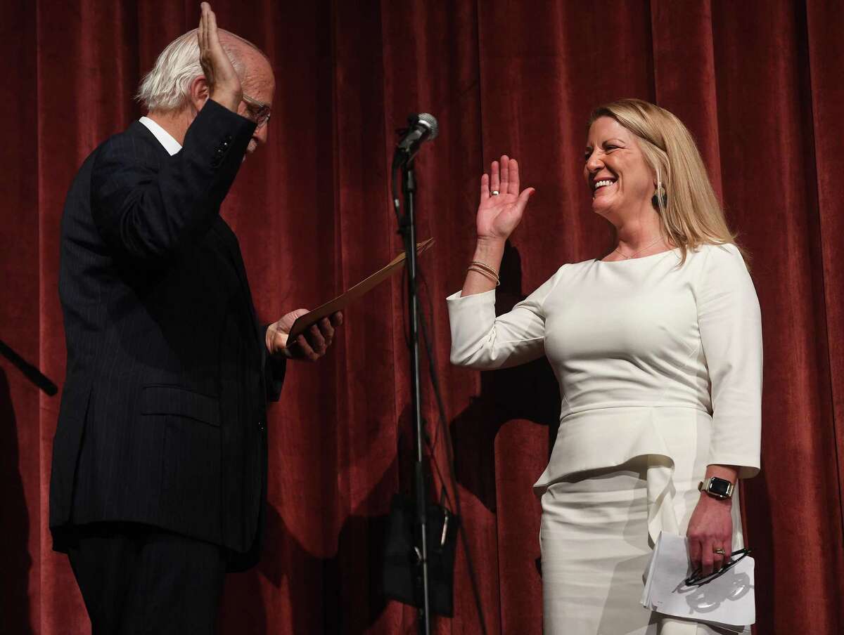 Newly elected Fairfield First Selectwoman Brenda Kupchick is sworn in by former U.S. Rep. Christopher Shays during the Oath of Office Ceremony at Warde High School in Fairfield, Conn. on Monday, November 25, 2019.